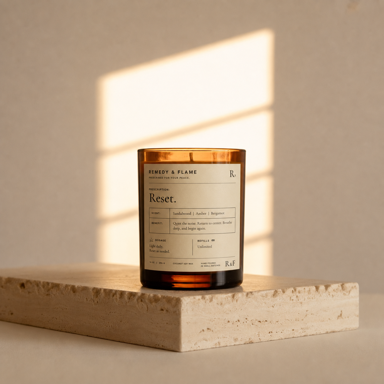The RESET candle in amber glass on travertine